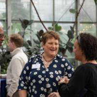 Cindy Brown and Edward Garner chatting with other femaie colleague